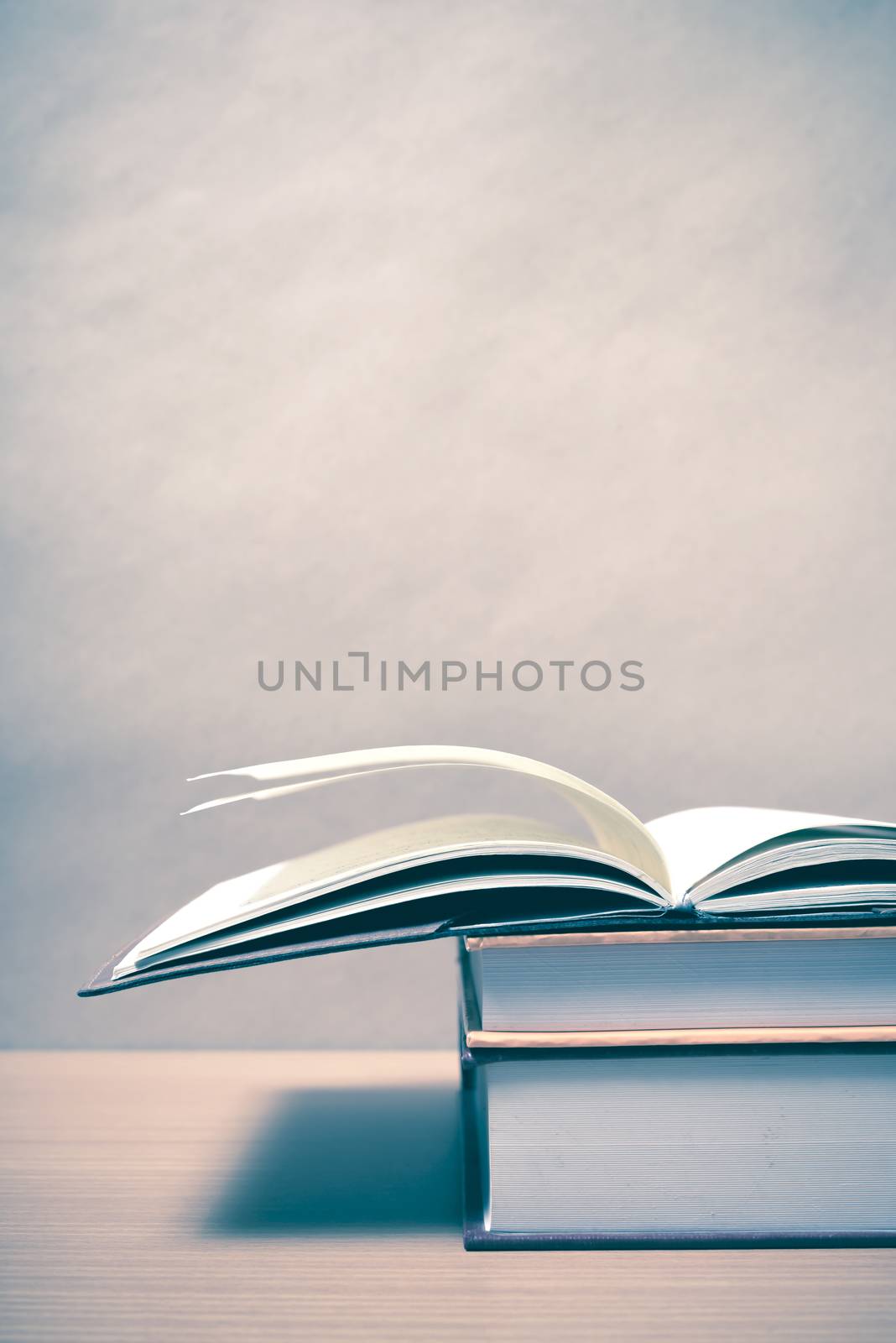 open book on wood background vintage style