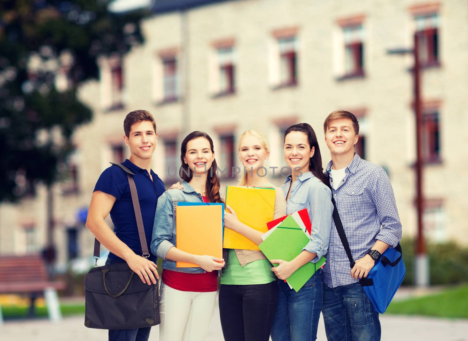 education and people concept - group of smiling students standing