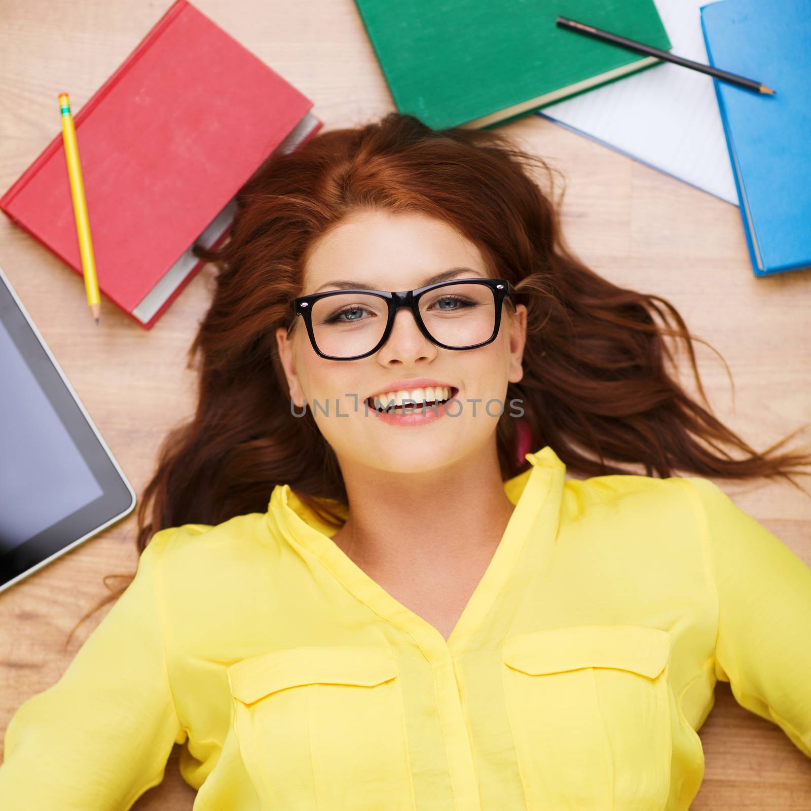 smiling student in eyeglasses lying on floor by dolgachov