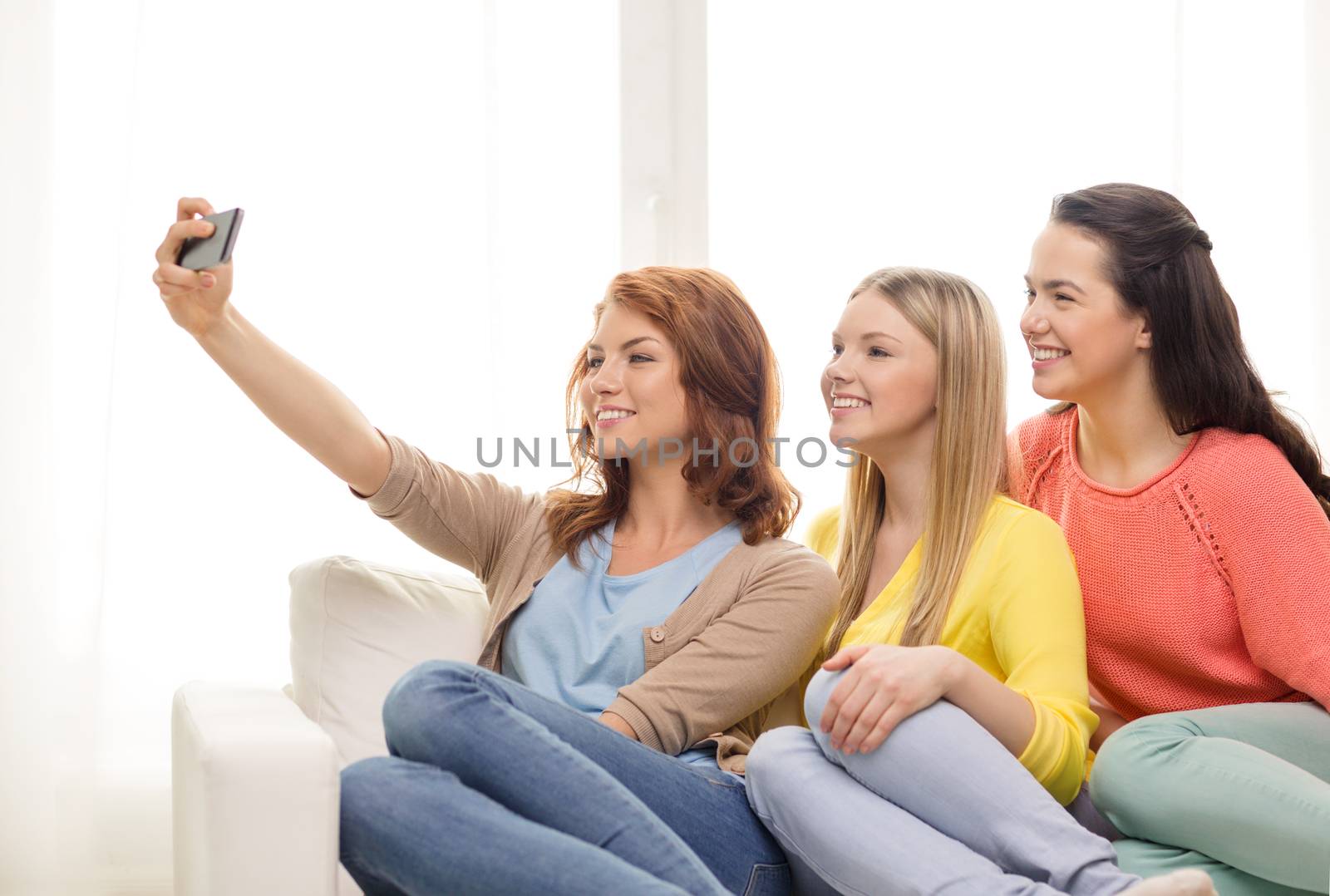 teenage girls taking selfie with smartphone by dolgachov