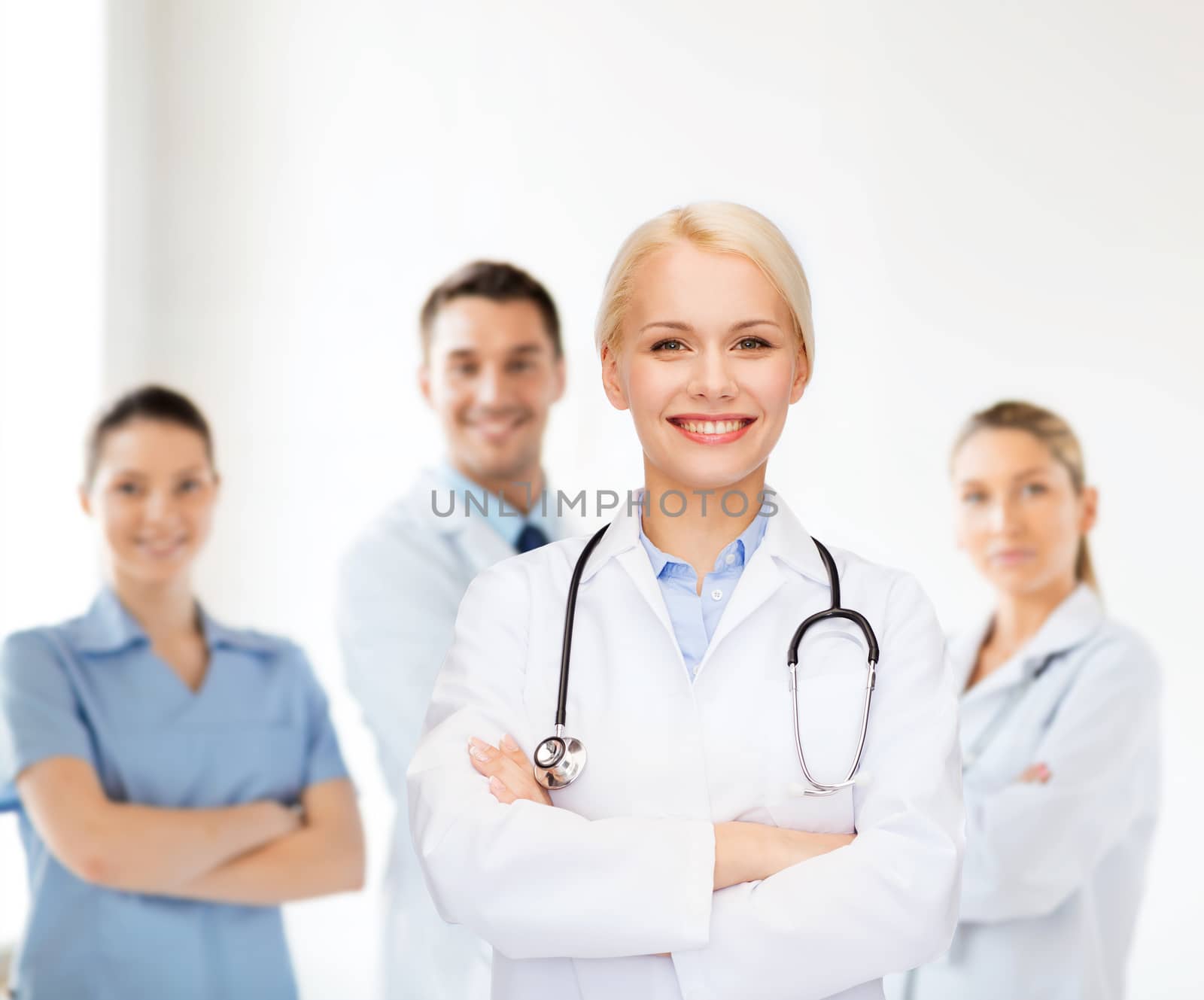 smiling female doctor with stethoscope by dolgachov