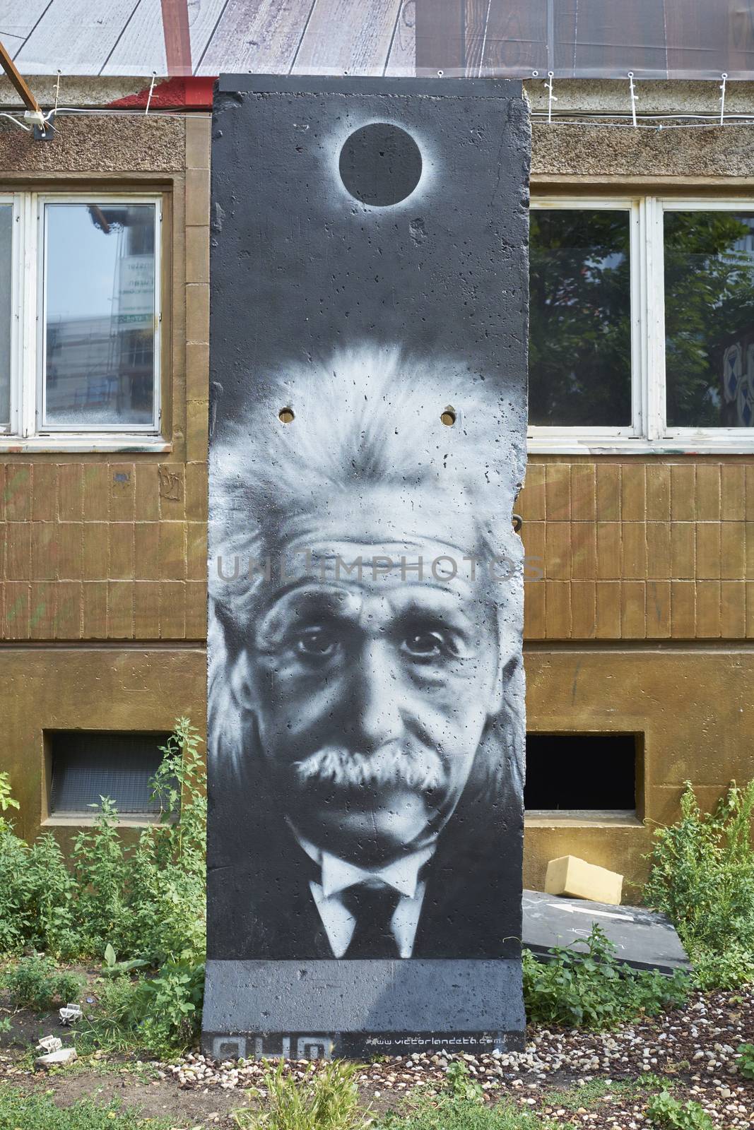 BERLIN, GERMANY - JULY 07: Segment of Berlin Wall in East Berlin with Albert Einstein portrait painted on. July 07, 2015 in Berlin.