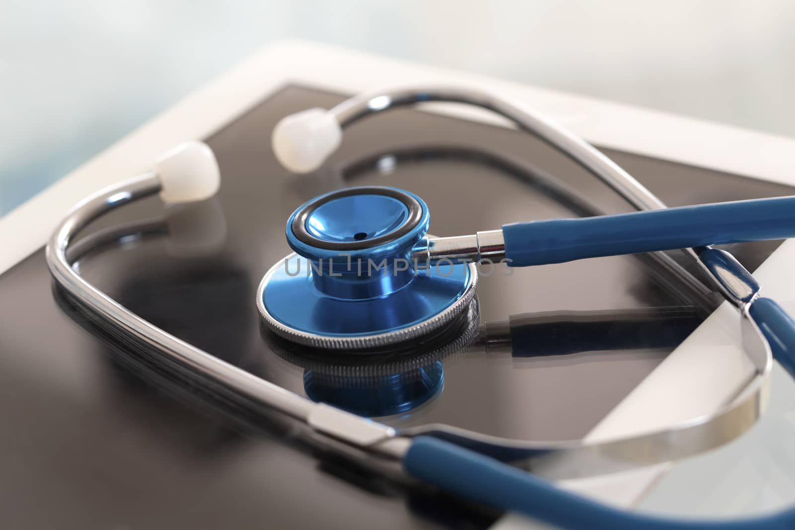 Doctor workplace with digital tablet and stethoscope