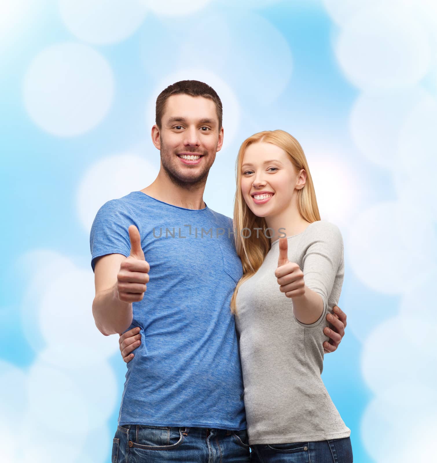 couple, gesture and family concept - smiling couple showing thumbs up