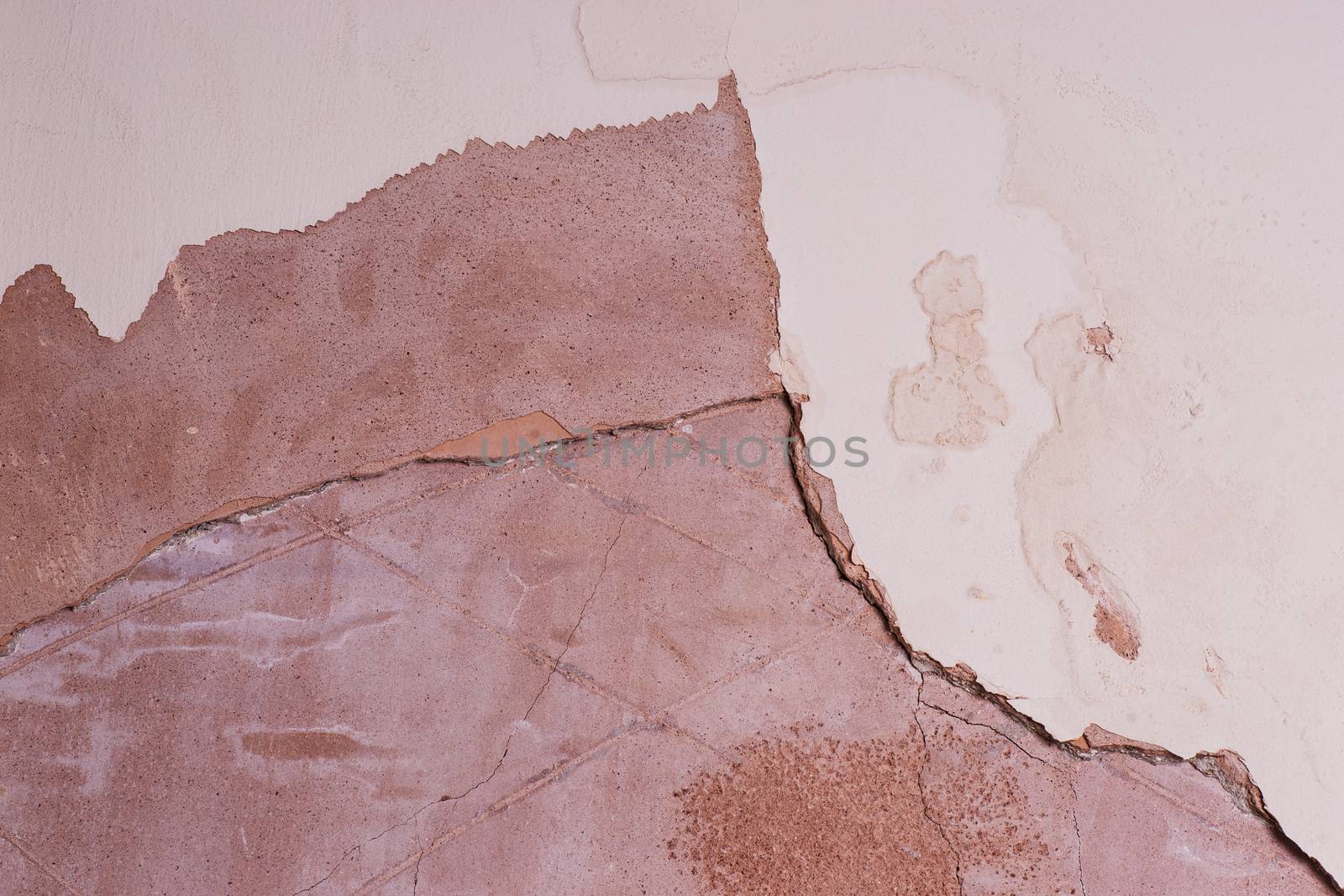 interior wall showing cracked and damaged plaster due to damp