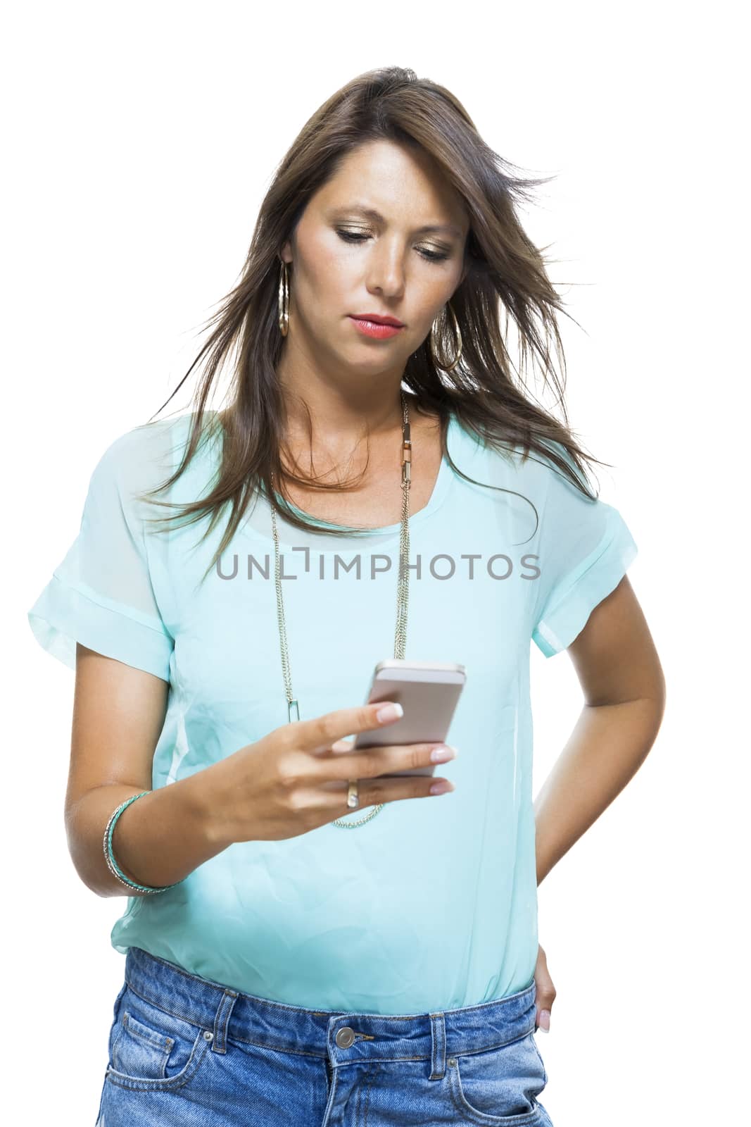 Portrait of Pretty Happy Woman in Casual Clothing Looking Something at her Mobile Phone on Hand. Captures in Studio with White Background.