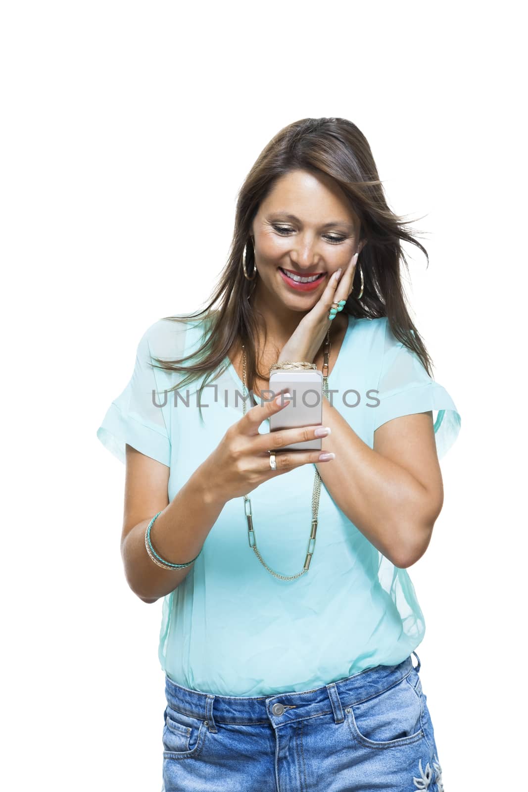 Portrait of Pretty Happy Woman in Casual Clothing Looking Something at her Mobile Phone on Hand. Captures in Studio with White Background.