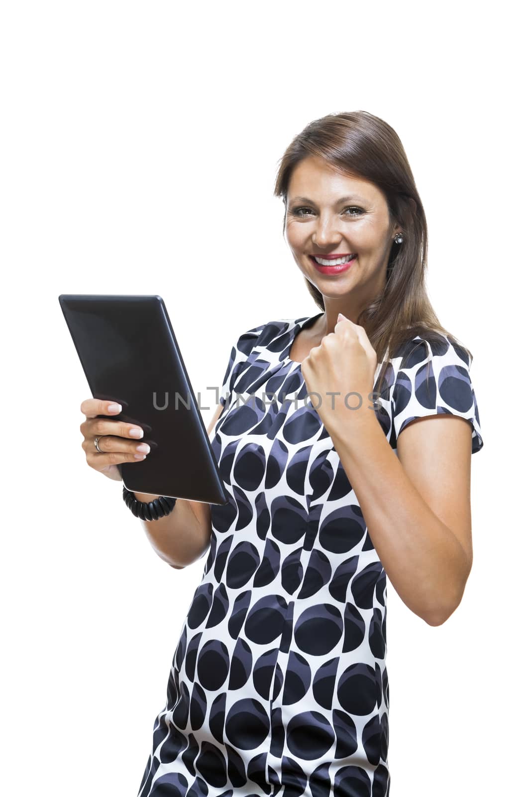 Portrait of a Smiling Lady in an Elegant Printed Dress Holding a Tablet Computer with Copy Space While Looking at the Camera. Isolated on White Background.