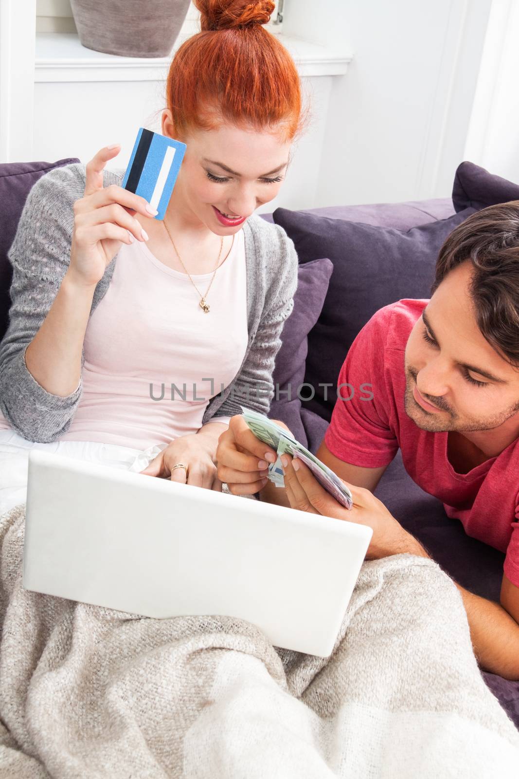 Sweet Young Couple Relaxing on the Couch in the Living Room, Watching a Movie on Laptop Computer Together.