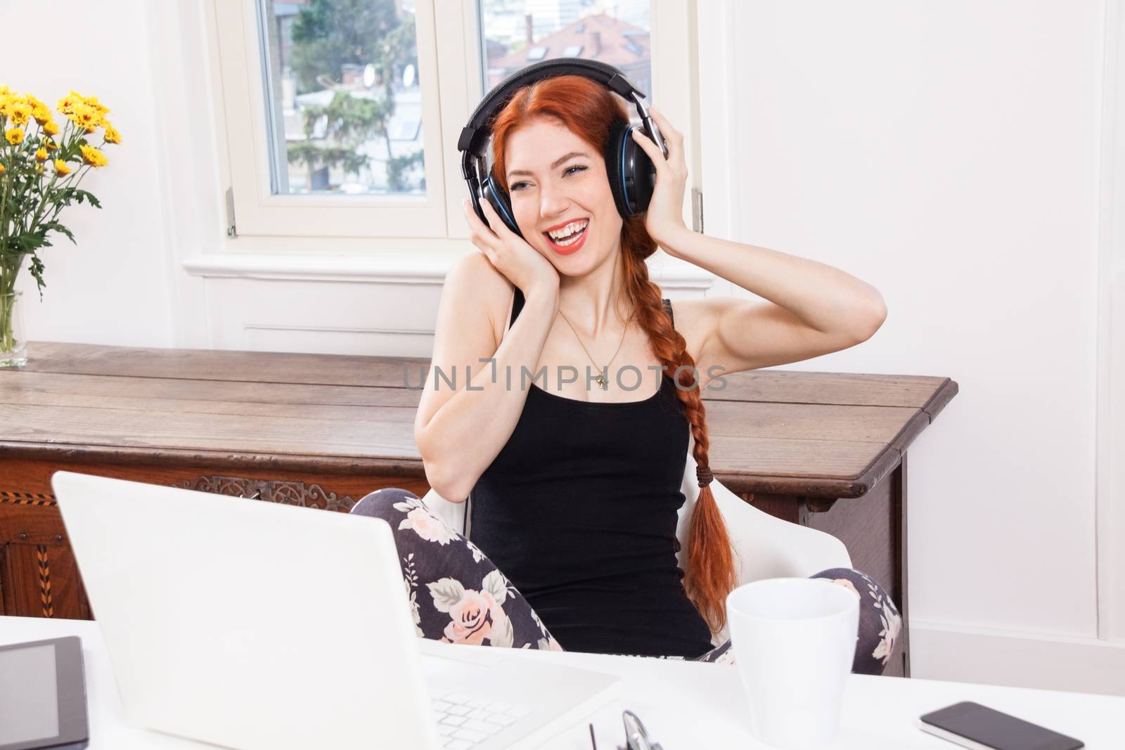 Happy Young Pretty Woman Laughing While Listening Funny Music Using Headphone Inside her Room.