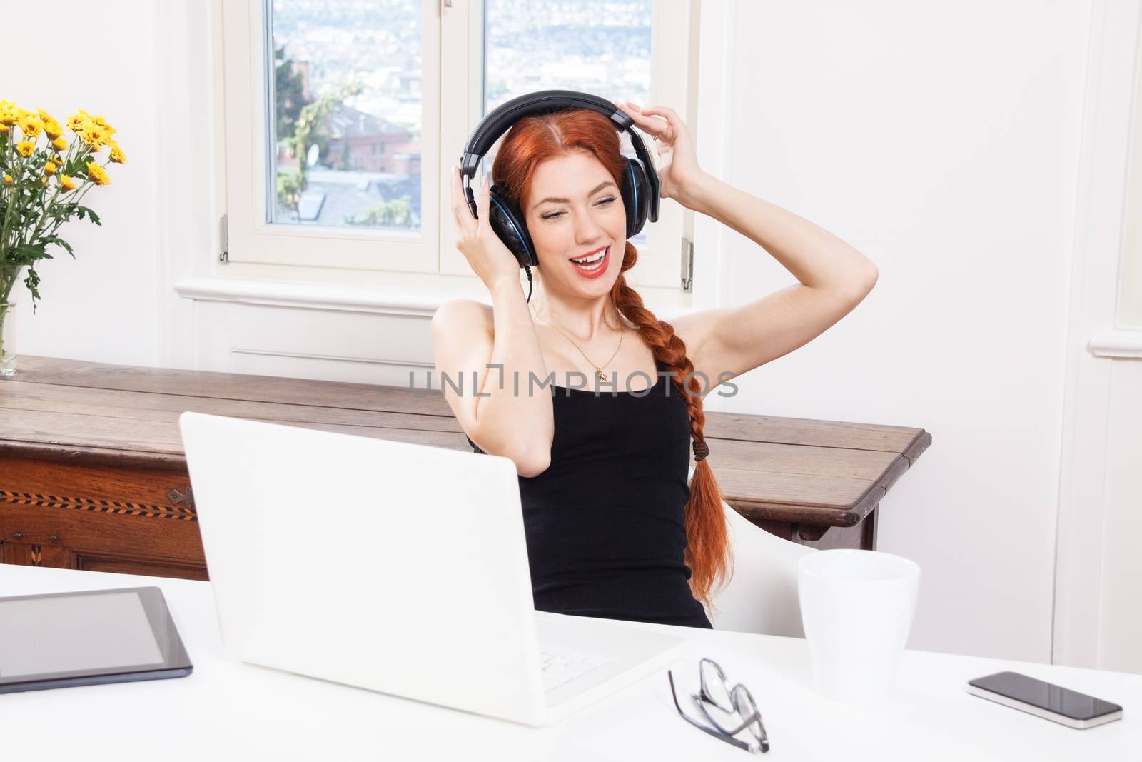Happy Young Pretty Woman Laughing While Listening Funny Music Using Headphone Inside her Room.