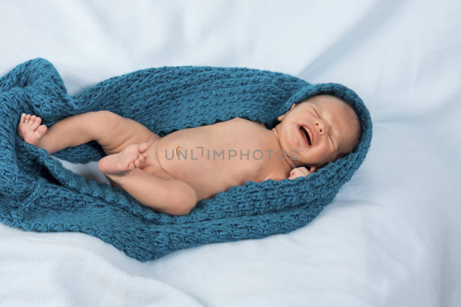 Close up Cute White New Born Baby Lying in Prone on White Cotton Cloth with Open Mouth