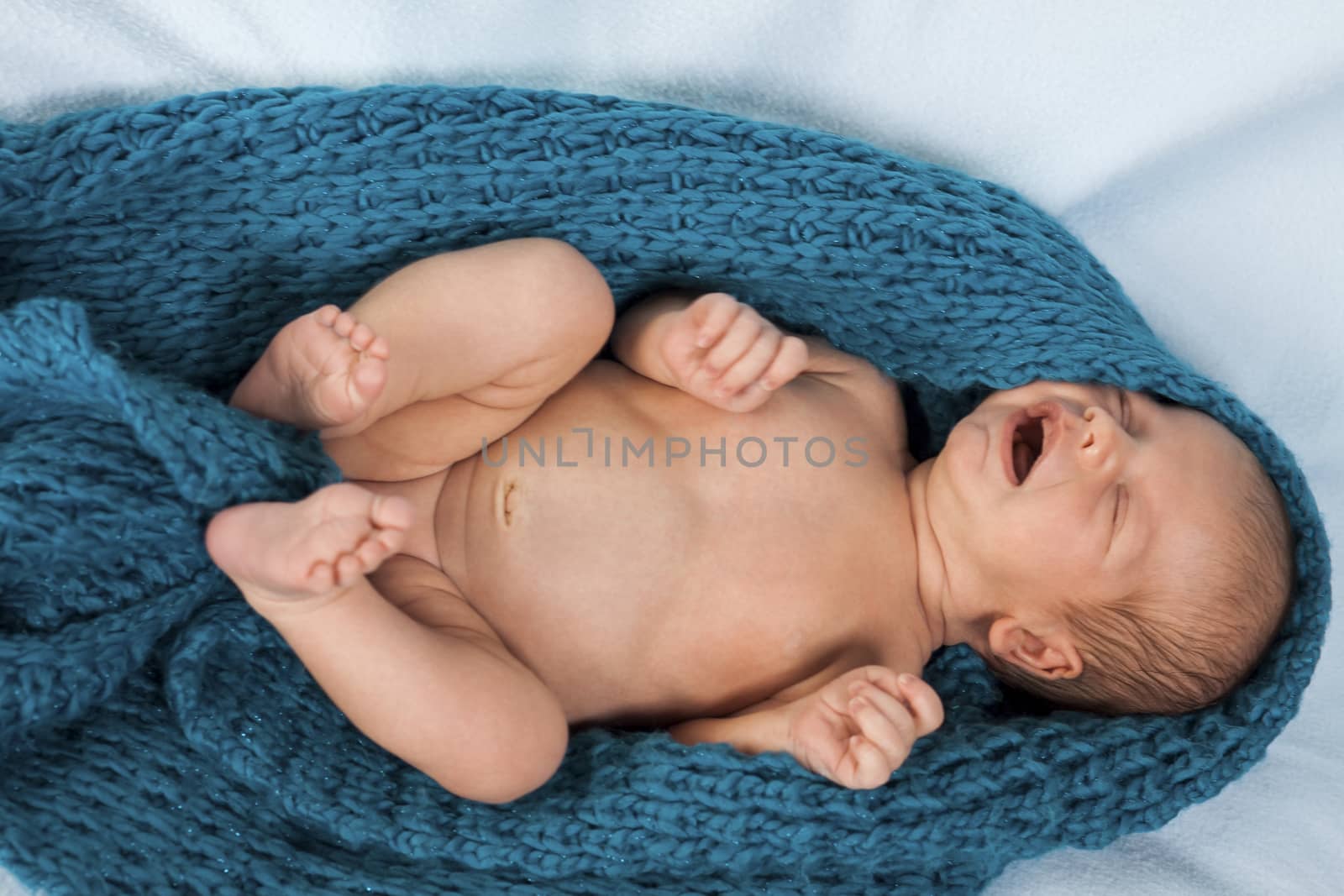 Close up Cute White New Born Baby Lying in Prone on White Cotton Cloth with Open Mouth
