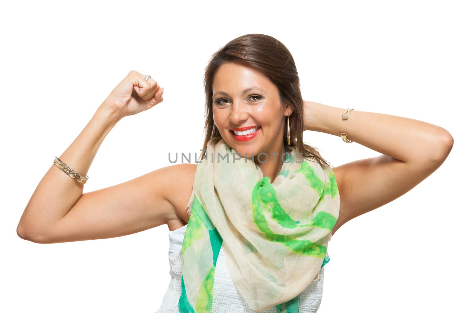 Close up Pretty Young Woman in Trendy Outfit, Showing her Arm Muscles While Holding Back Hair and Looking at the Camera. Isolated on White Background.