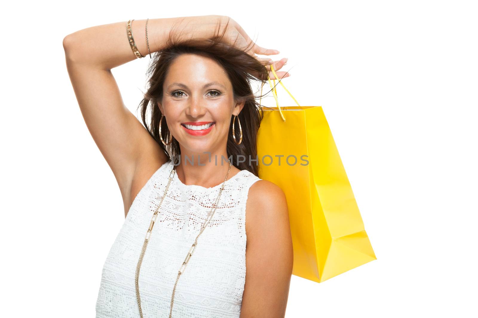 Very Happy Stylish Woman Raising Three Colored Shopping Paper Bag with Mouth Open and Looking at the Camera. Isolated on White Background.