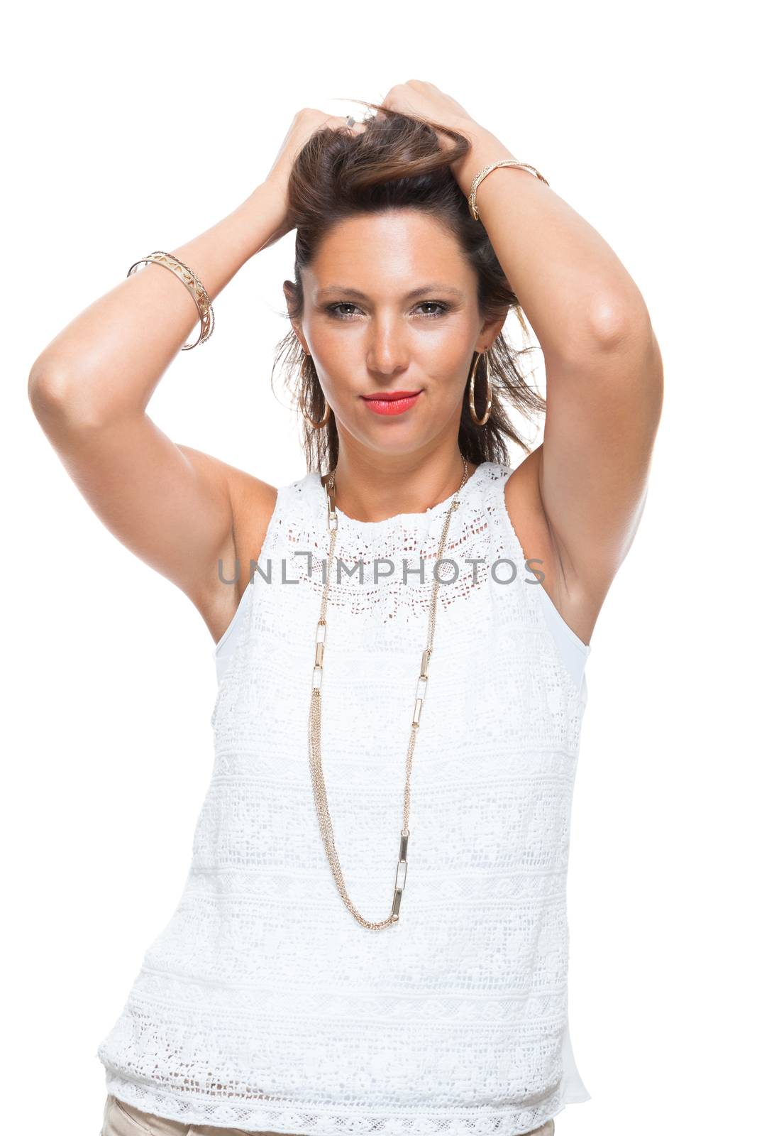 Half Body Shot of a Smiling Attractive Woman in Trendy Outfit, Holding her Hair Up While Looking at the Camera. Isolated on White Background.