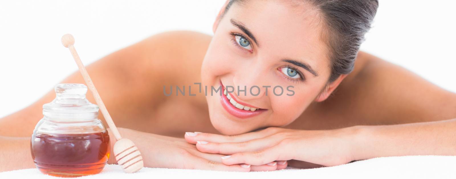 Portrait smiling pretty brunette on massage table with white backgroung