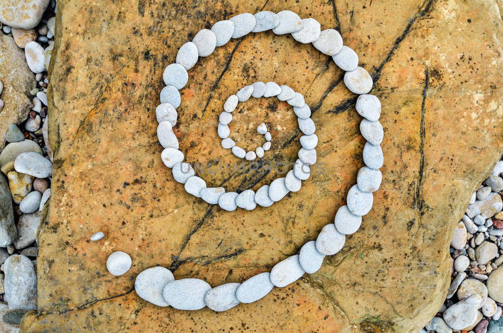 Spiral of pebbles on the stony coast