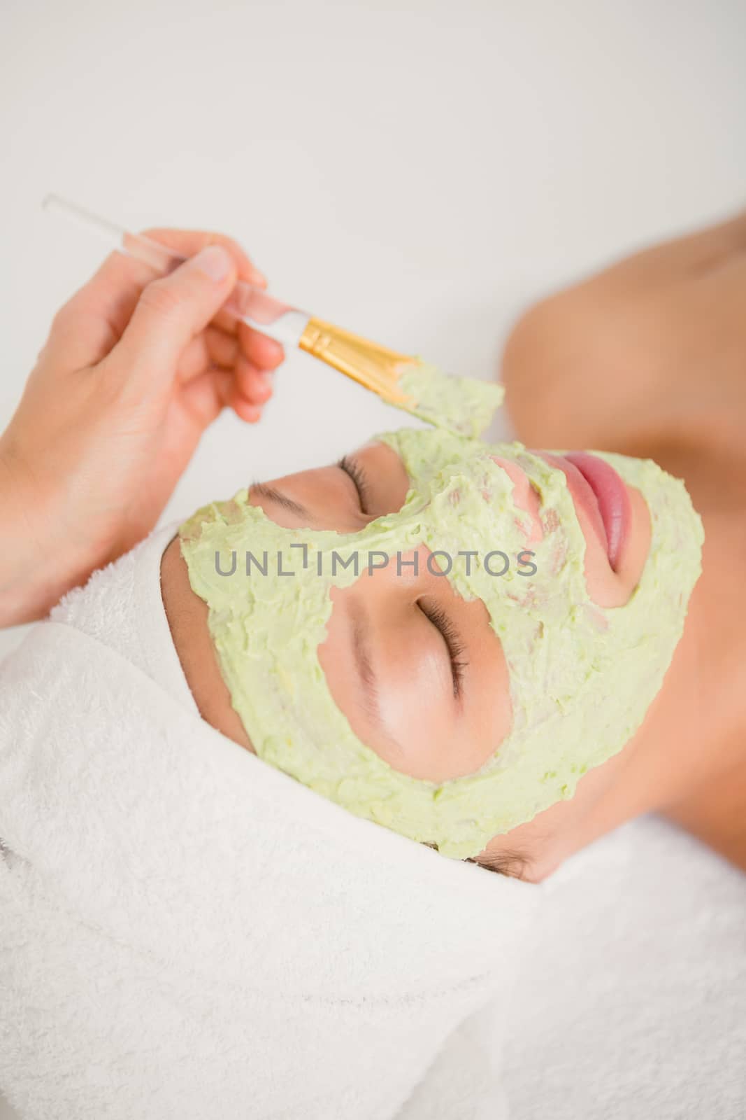 Attractive young woman receiving treatment at spa center by Wavebreakmedia