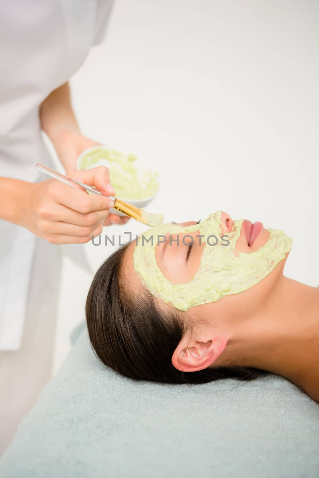 Attractive woman receiving treatment at spa center by Wavebreakmedia