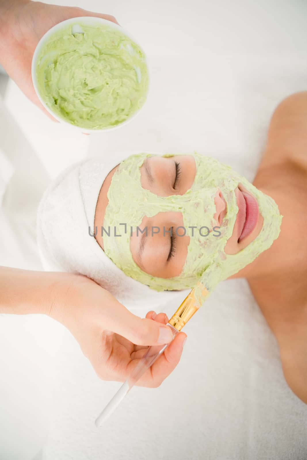 Attractive woman receiving treatment at spa center by Wavebreakmedia