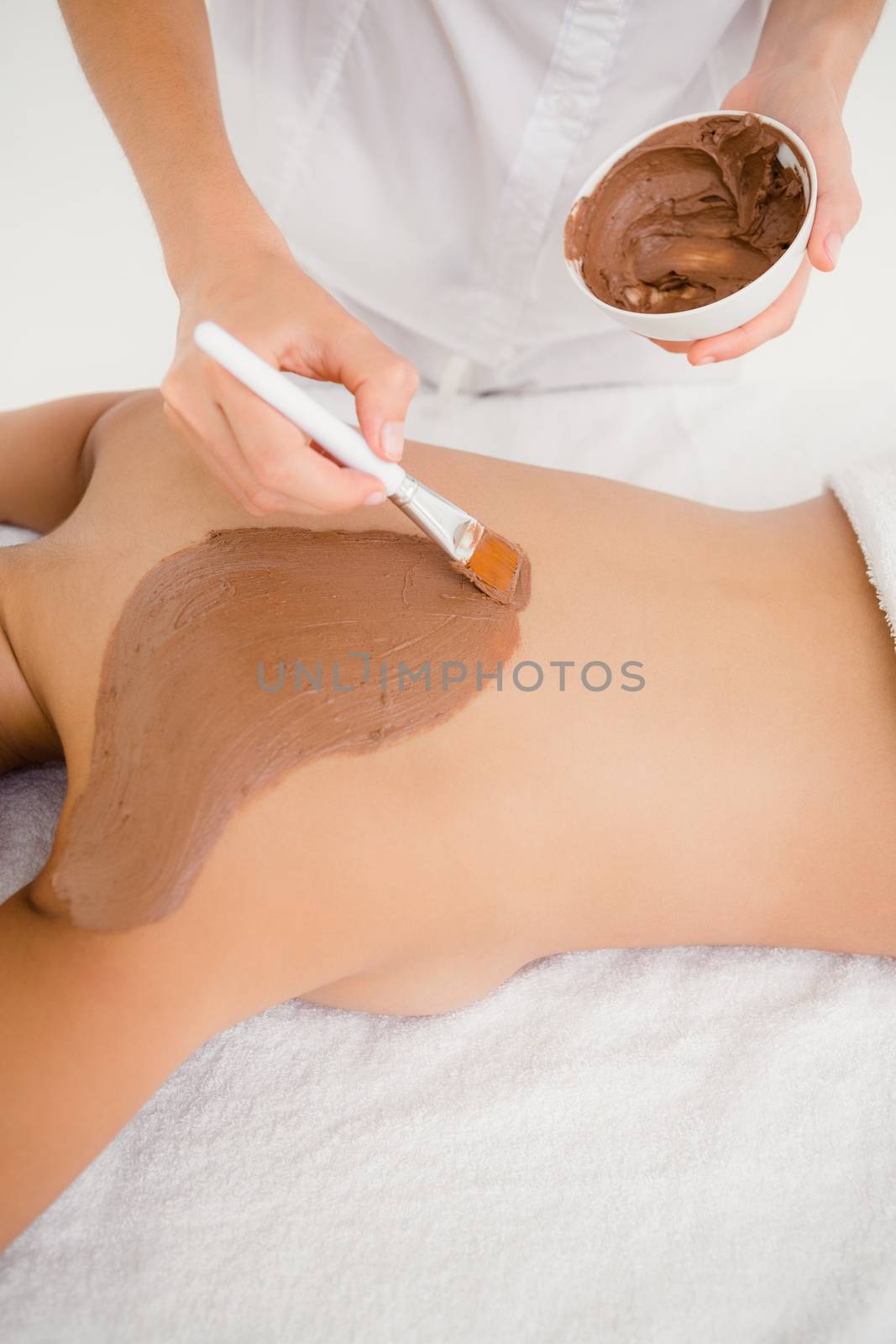 Woman enhoying a chocolate beauty treatment at the health spa 