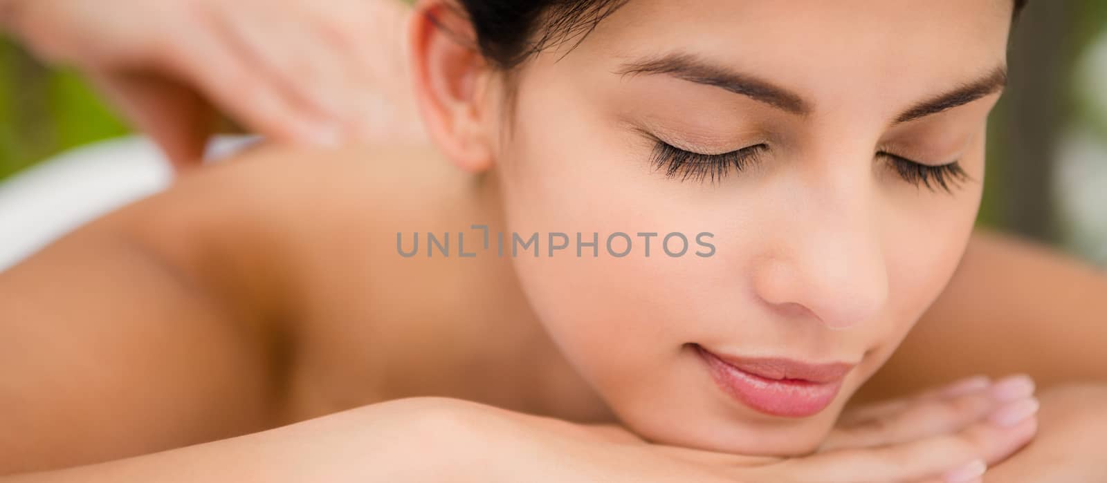 Attractive woman receiving back massage at spa center