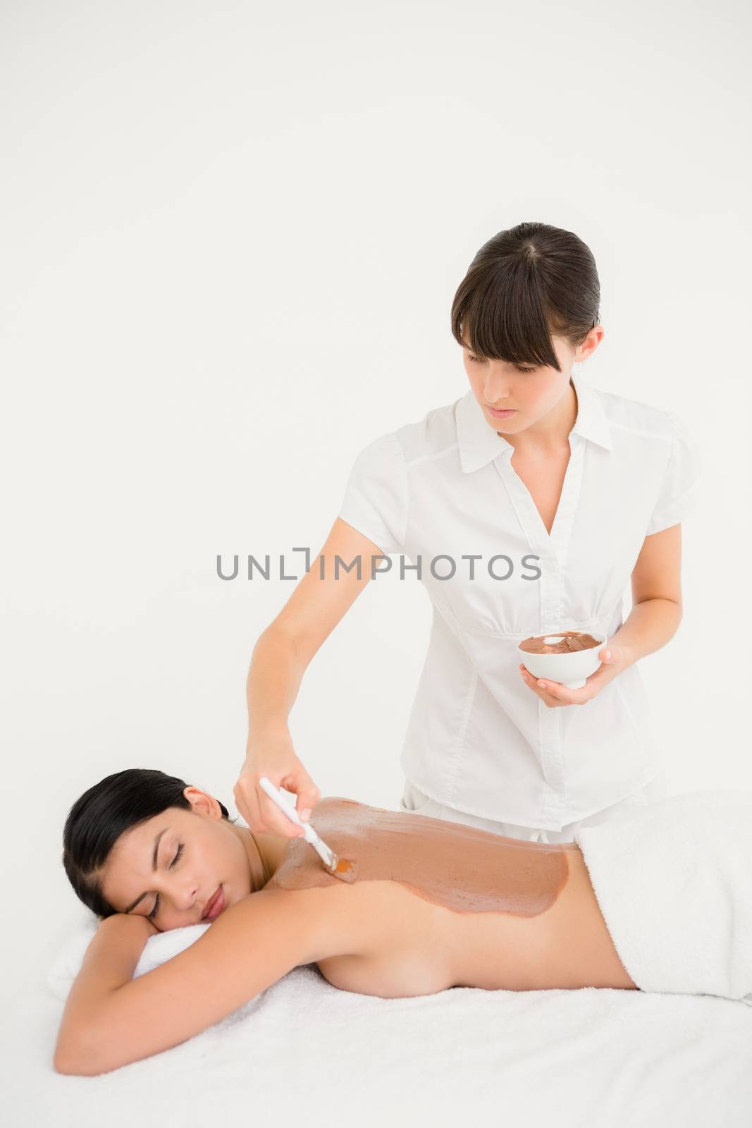 Beautiful brunette enjoying a chocolate beauty treatment at the health spa