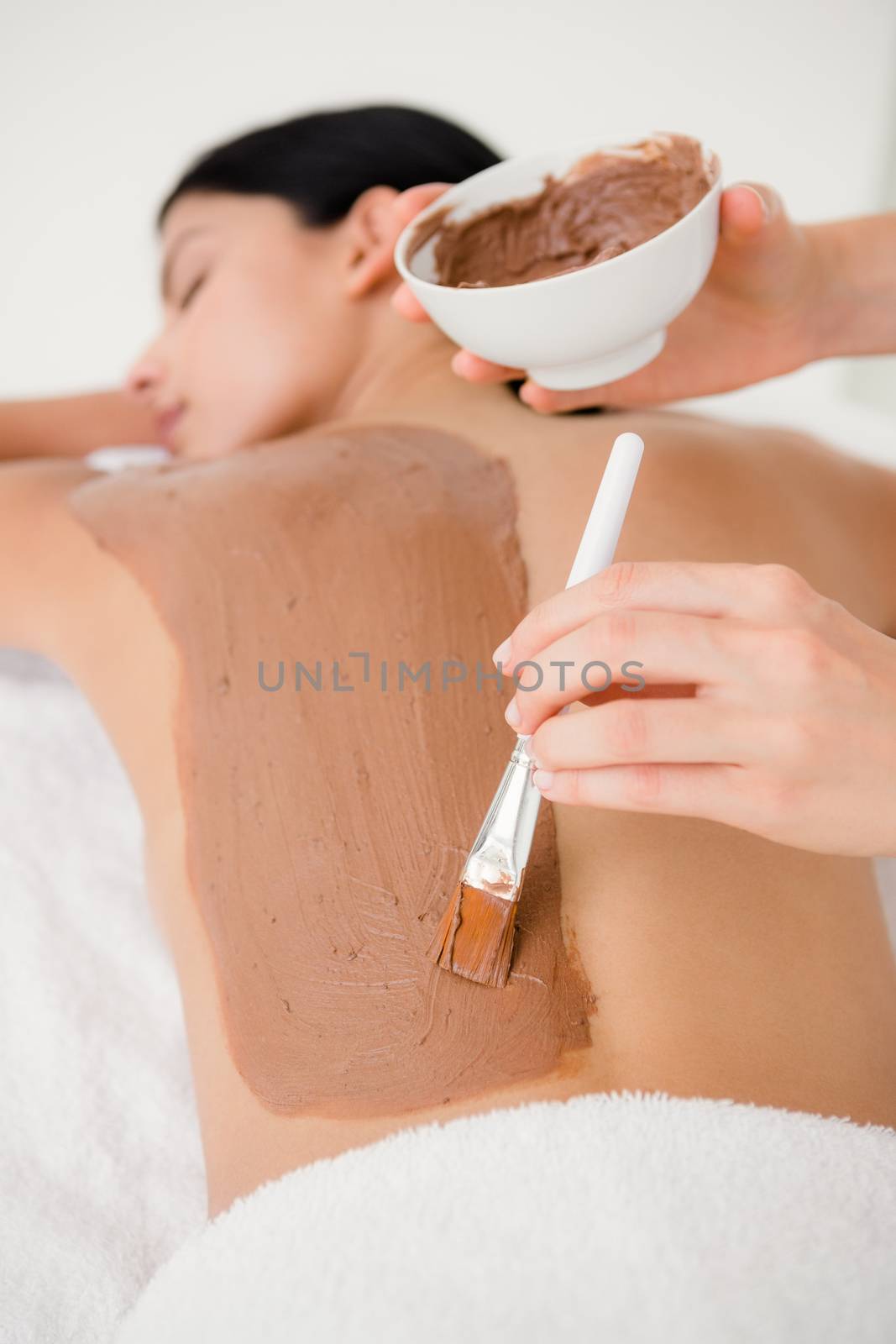 Beautiful brunette enjoying a chocolate beauty treatment by Wavebreakmedia