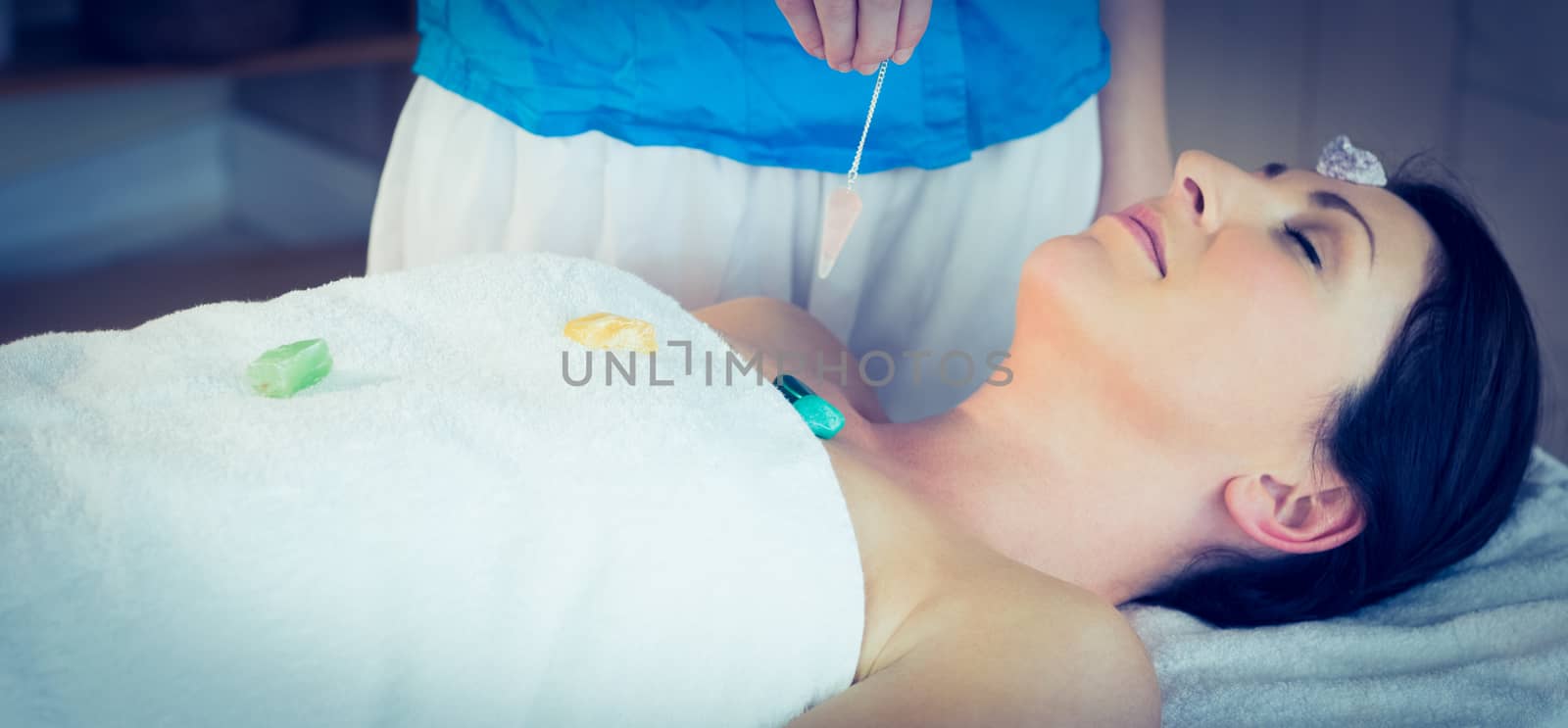 Young woman at crystal healing session in therapy room