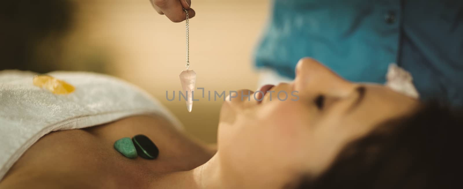 Young woman at crystal healing session by Wavebreakmedia