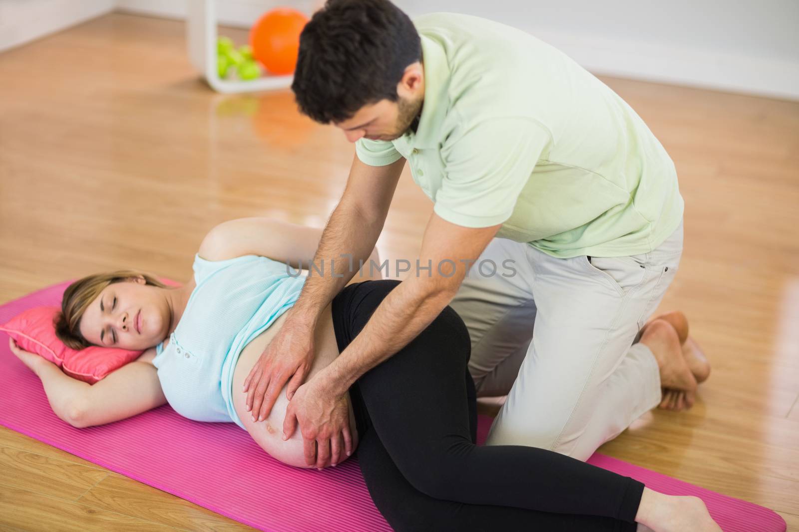 Pregnant woman getting massage for pregnant belly by Wavebreakmedia