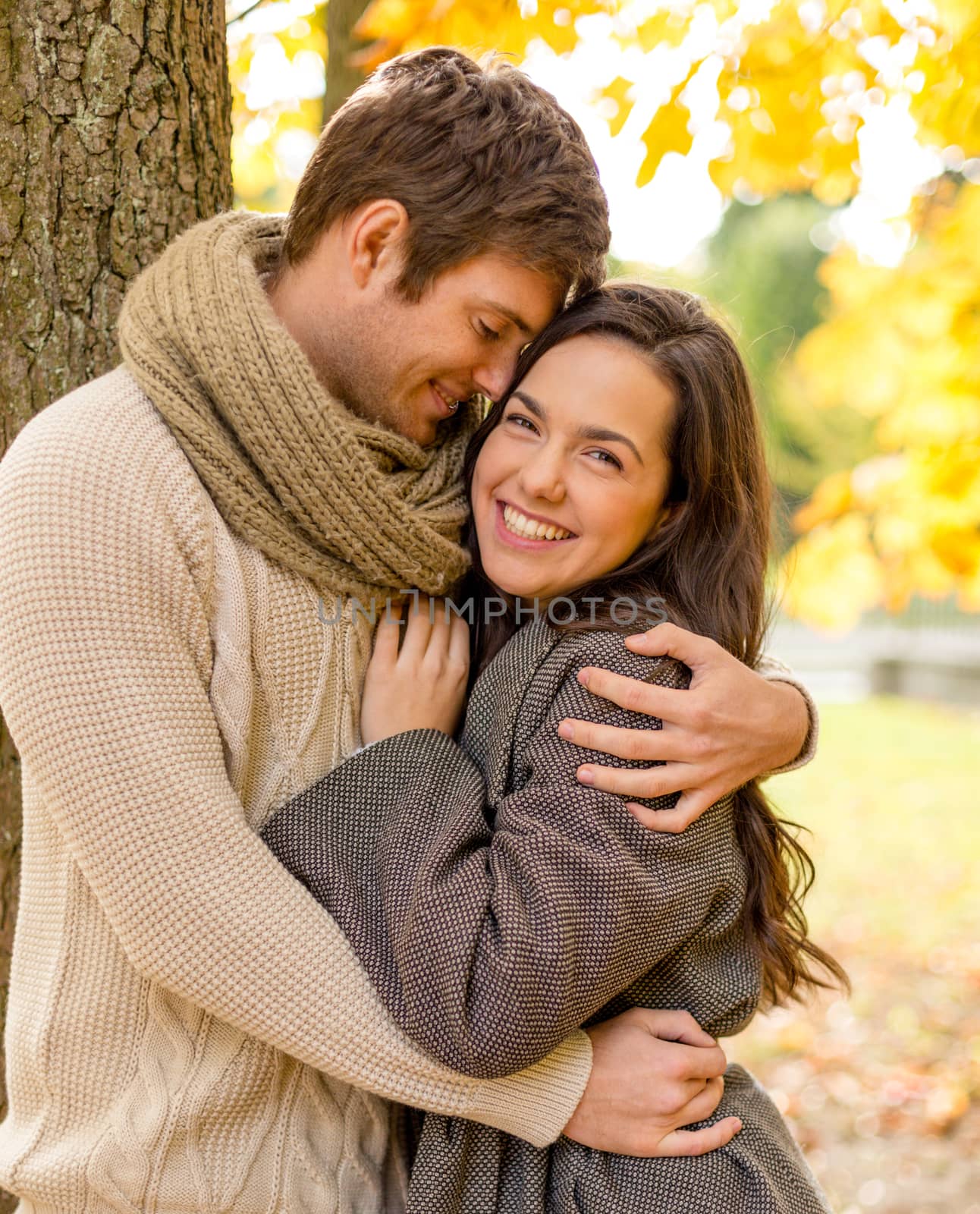 smiling couple hugging in autumn park by dolgachov