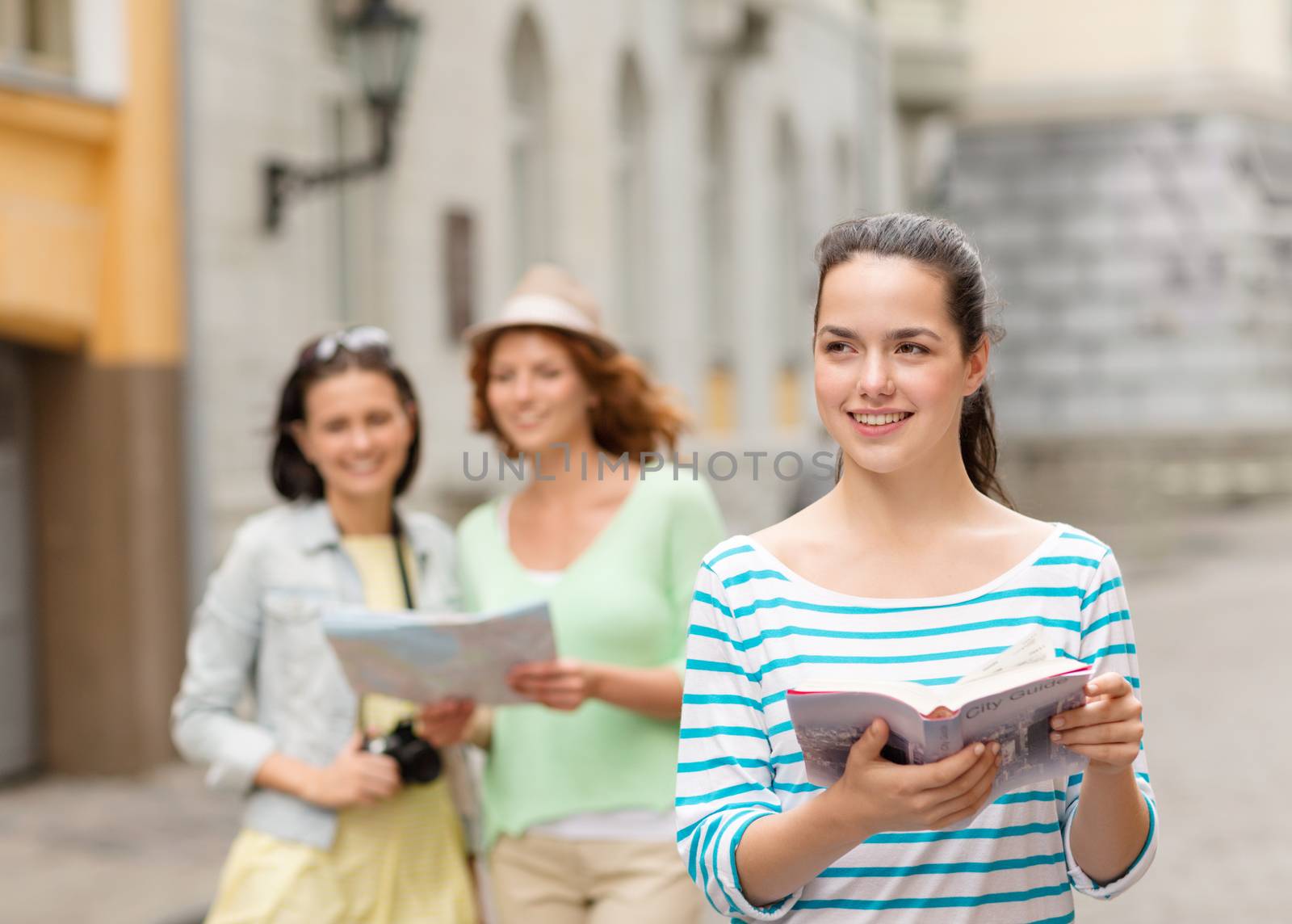 tourism, travel, leisure and holidays concept - smiling teenage girls with city guide, map and camera outdoors