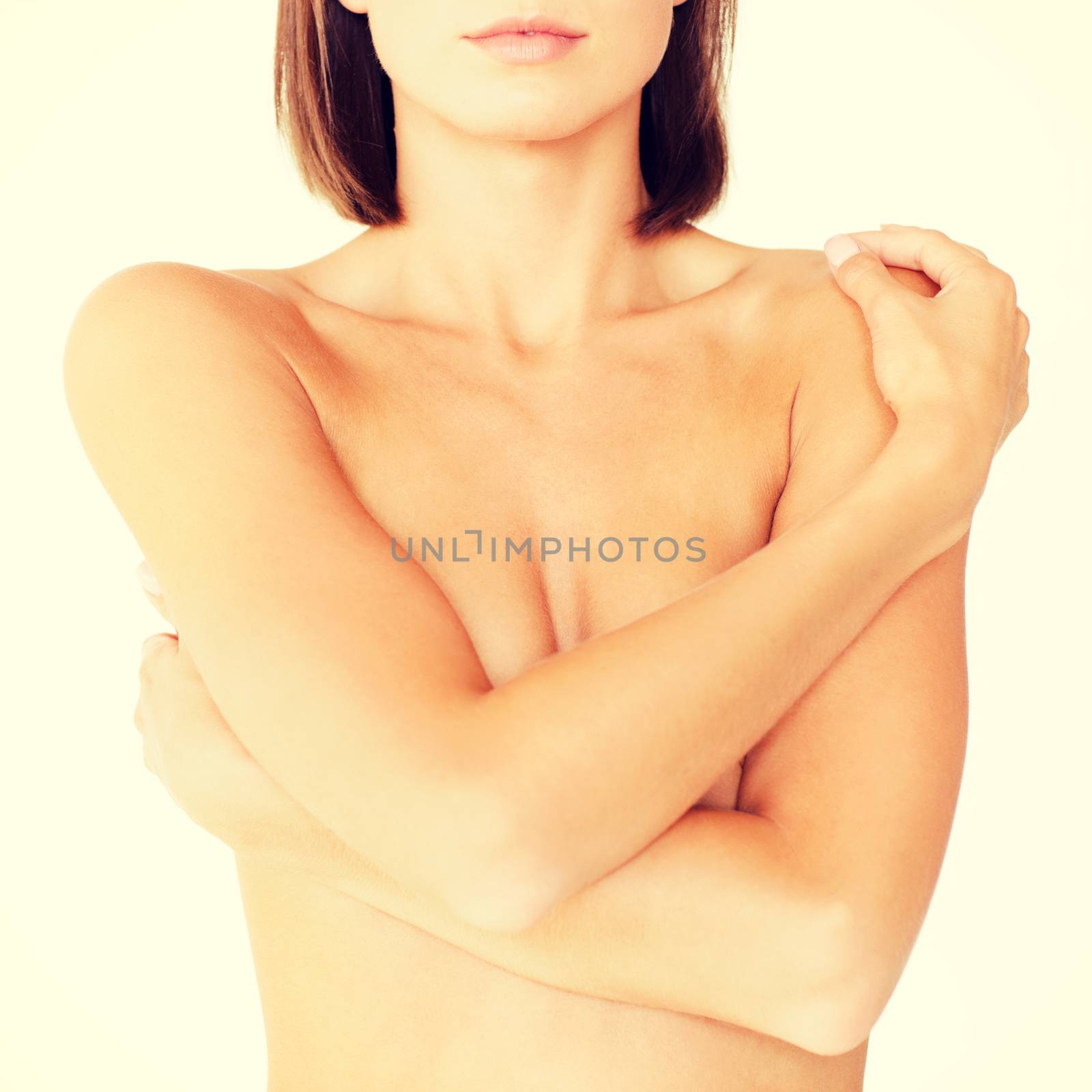 woman with perfect skin and hands over breast by dolgachov