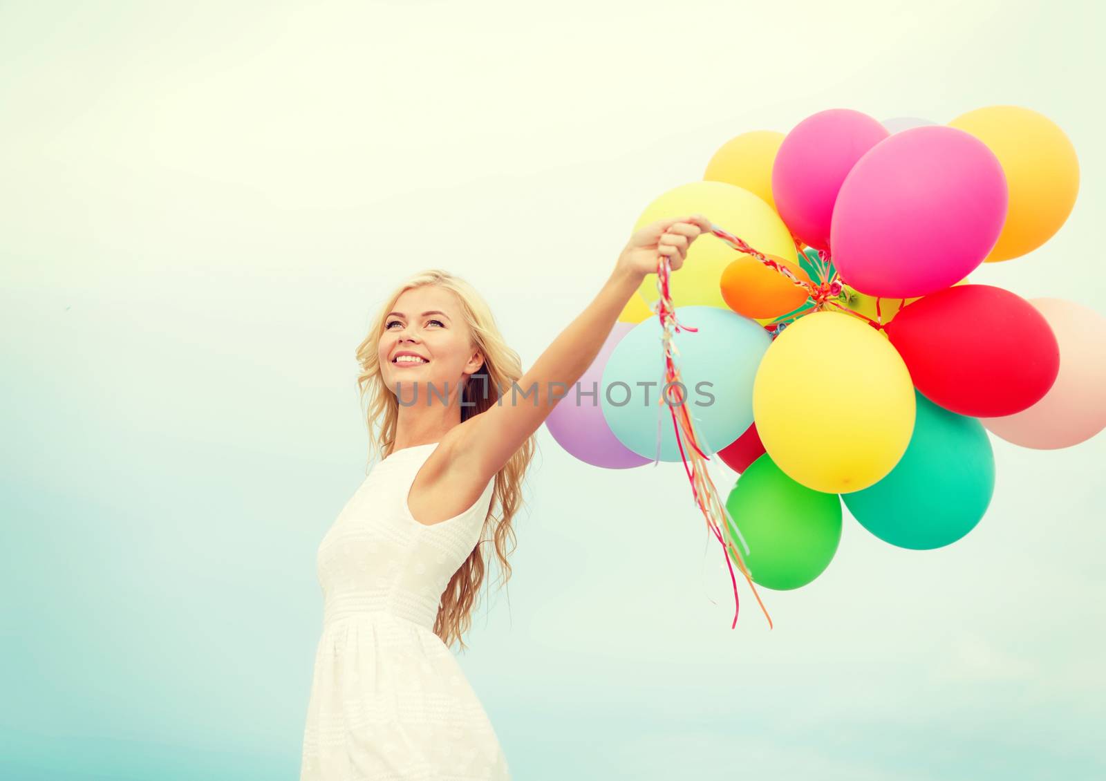 summer holidays, celebration and lifestyle concept - beautiful woman with colorful balloons outside