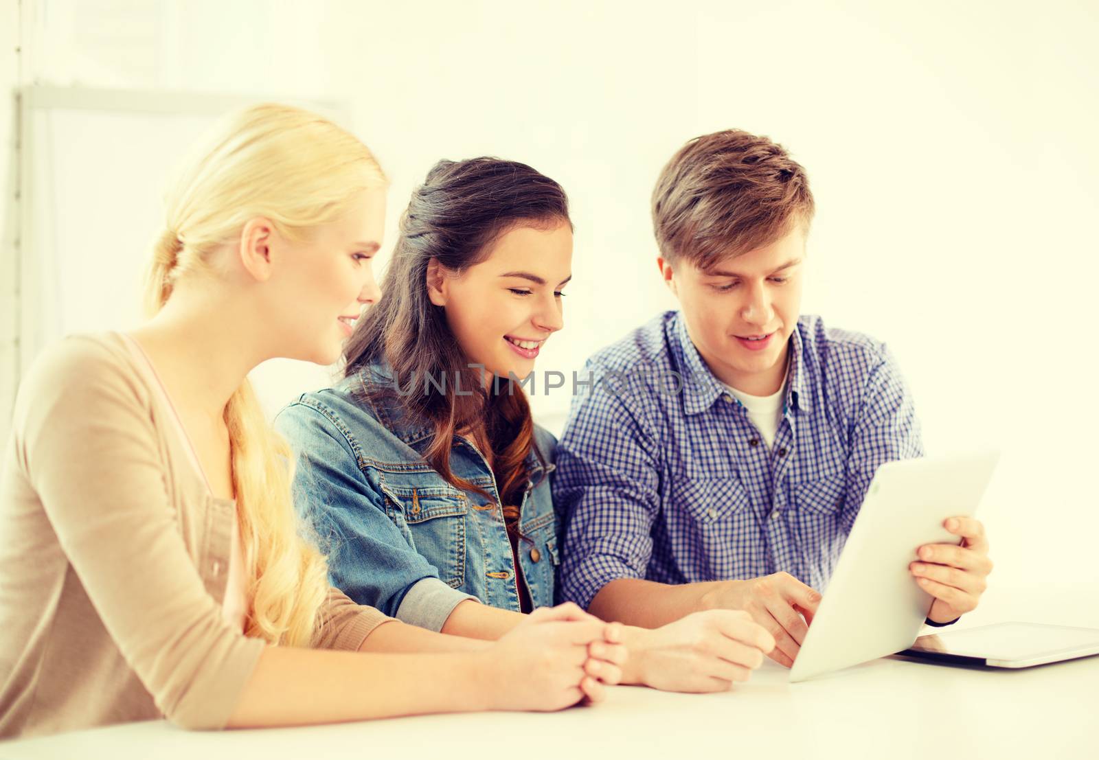 technology, internet, school and education concept - group of smiling teenage students with tablet pc computers at school