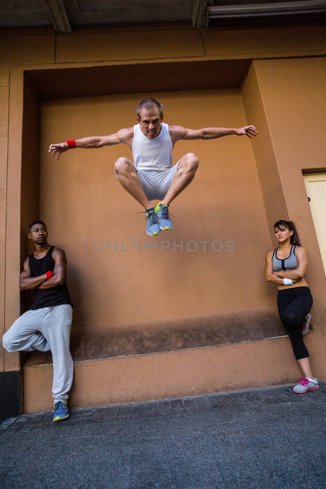 Group of people doing parkour in the city by Wavebreakmedia