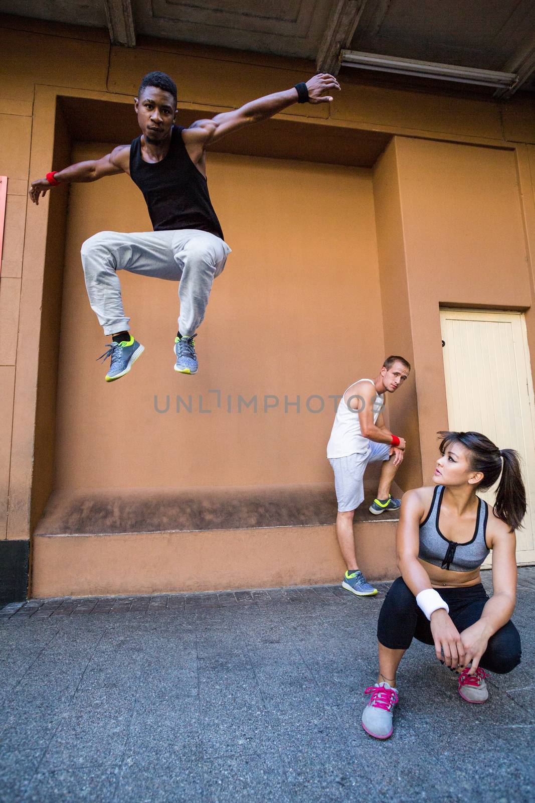 Group of people doing parkour in the city by Wavebreakmedia