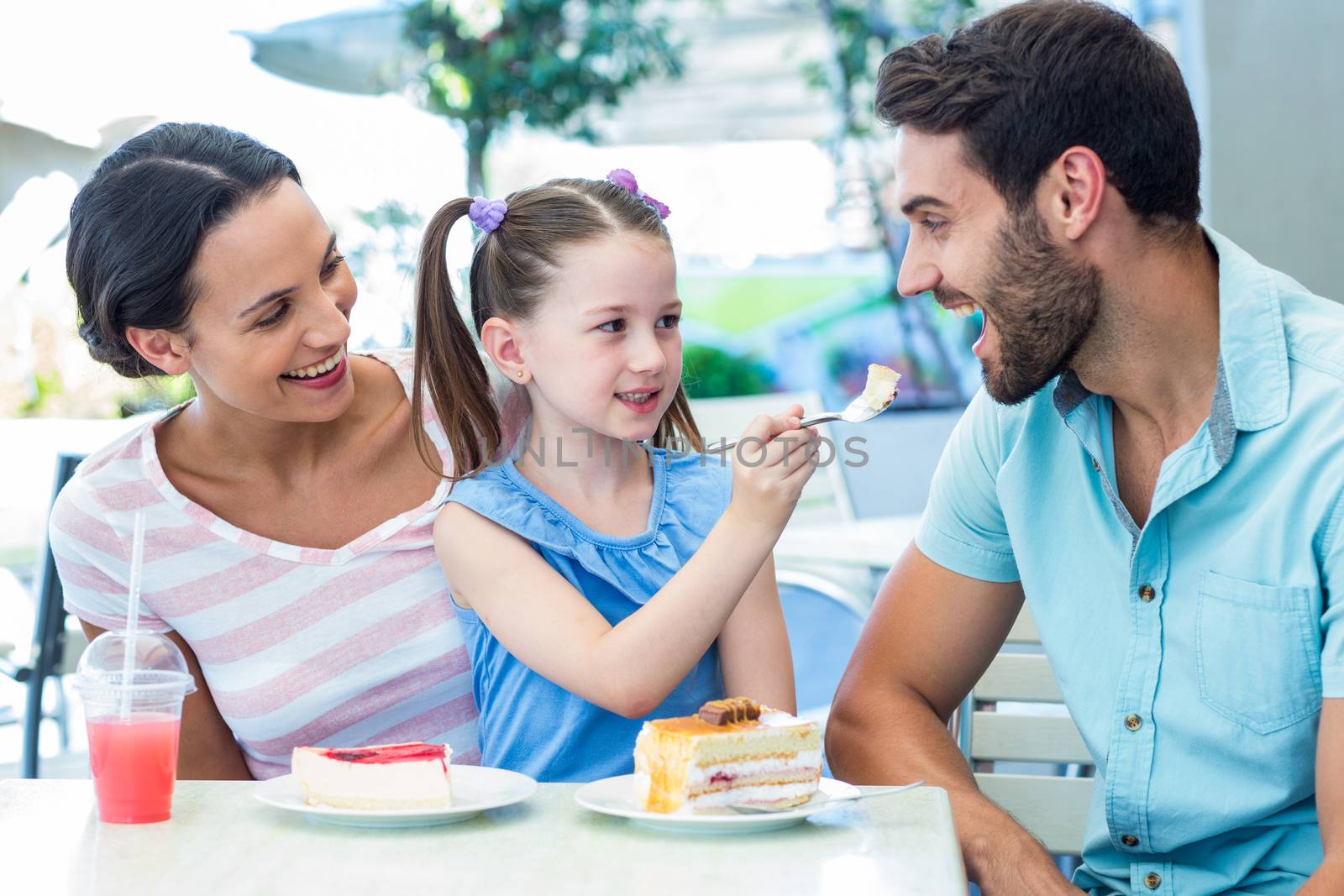 A family eating at the restaurant on a sunny day