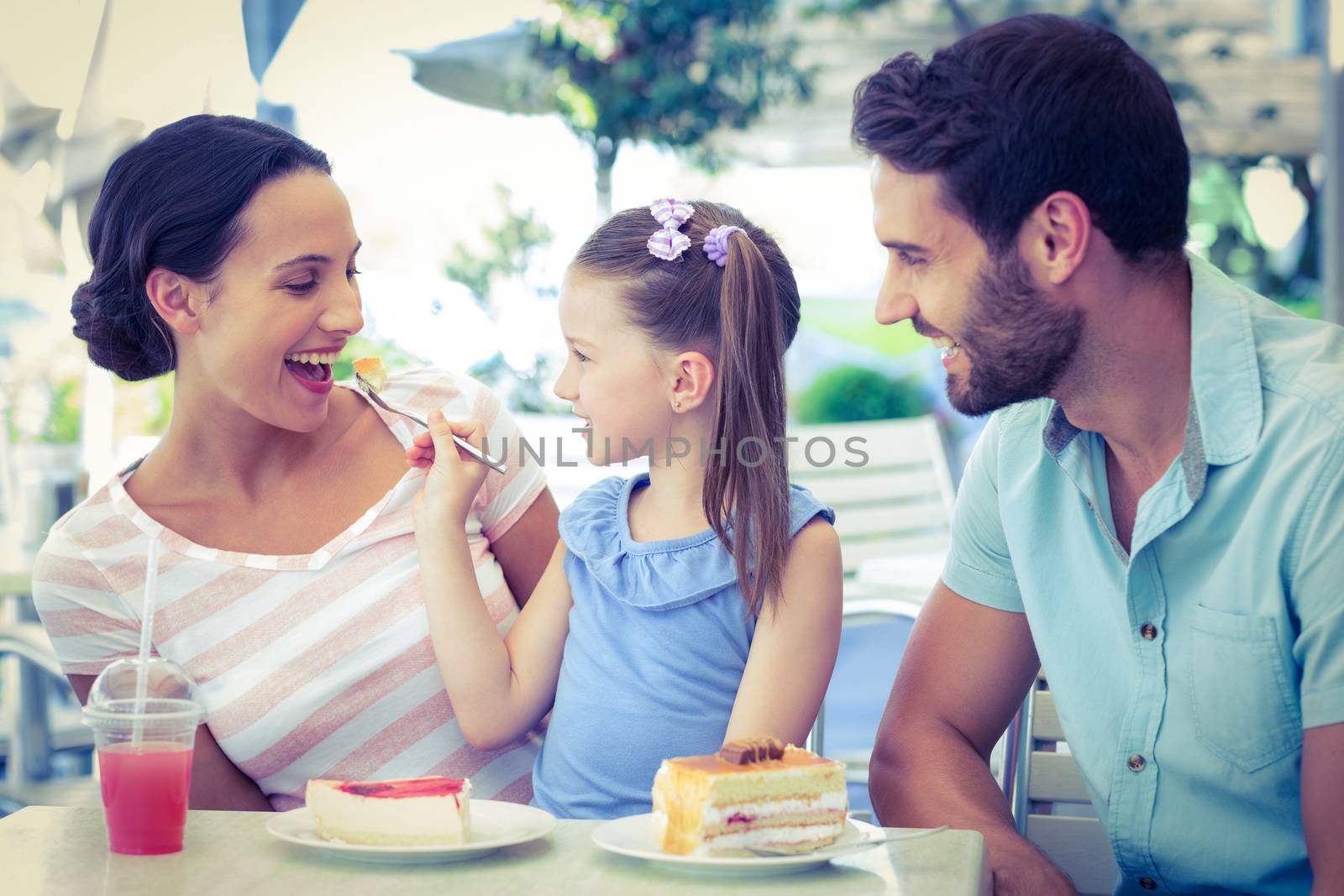 A family eating at the restaurant on a sunny day