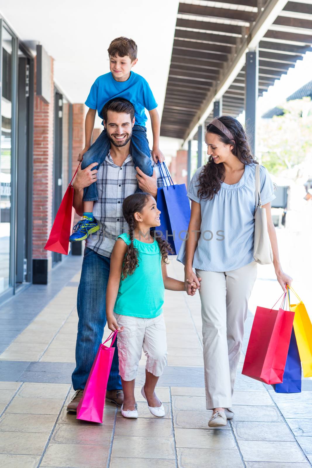 Happy family having fun in the mall by Wavebreakmedia