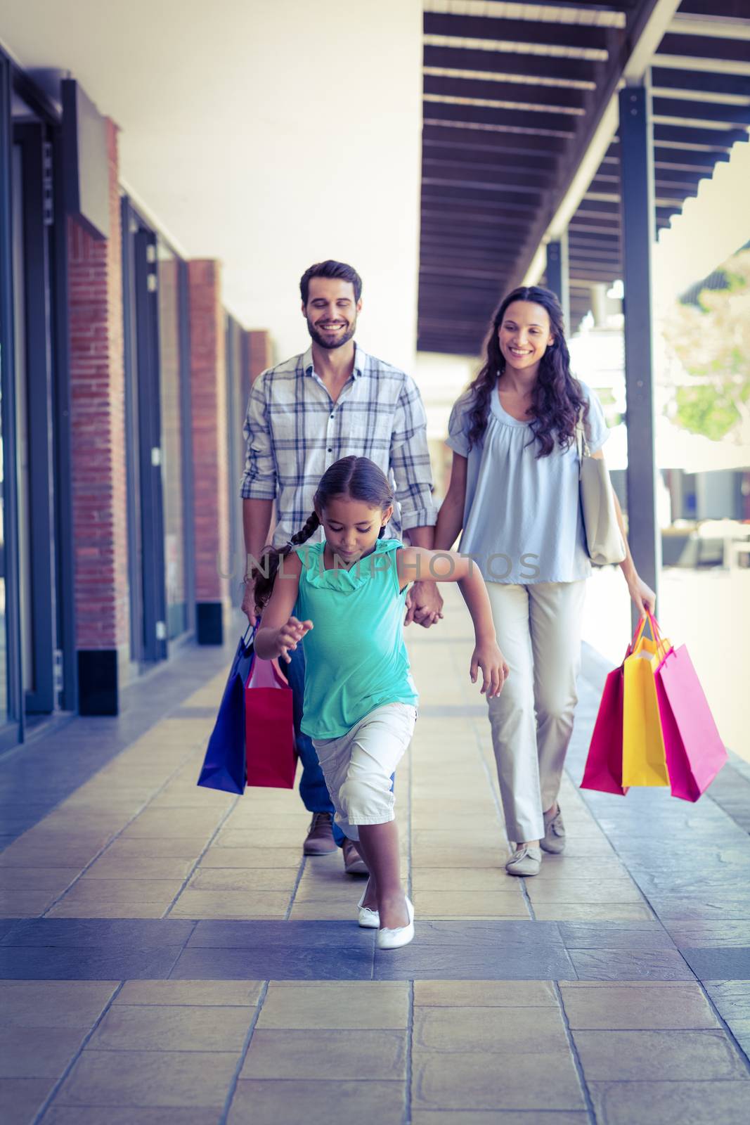 Happy family with shopping bags at the mall