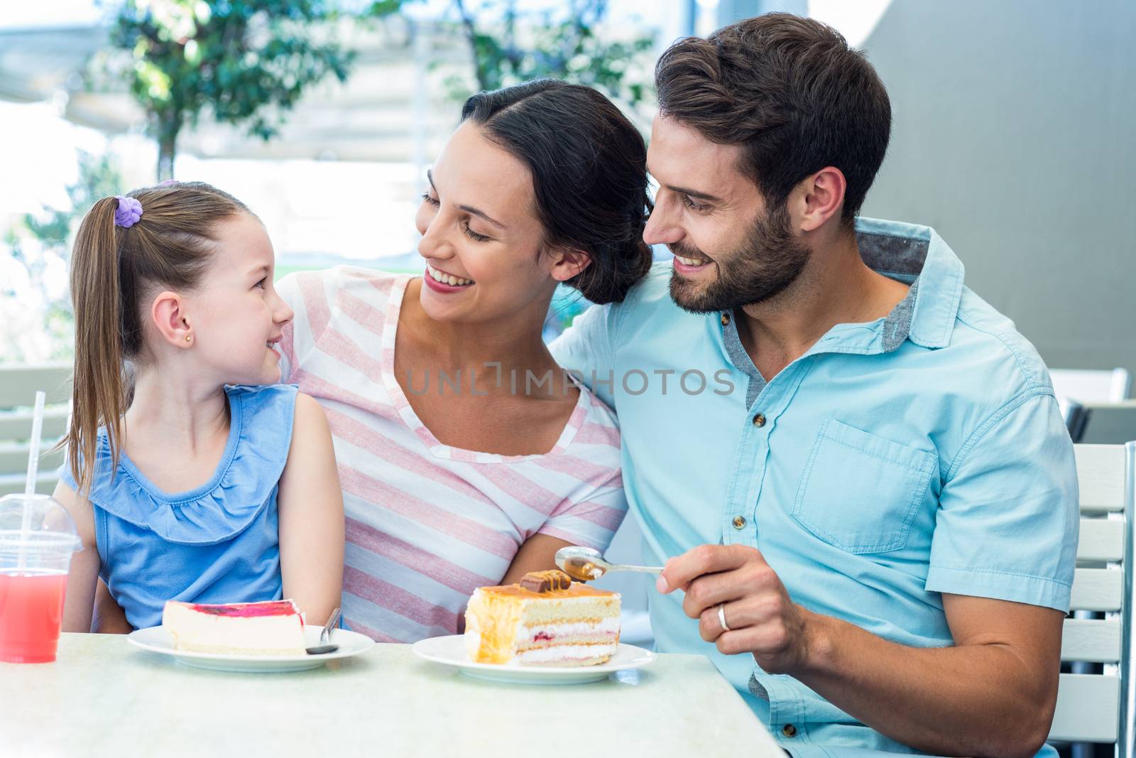 A family eating at the restaurant by Wavebreakmedia