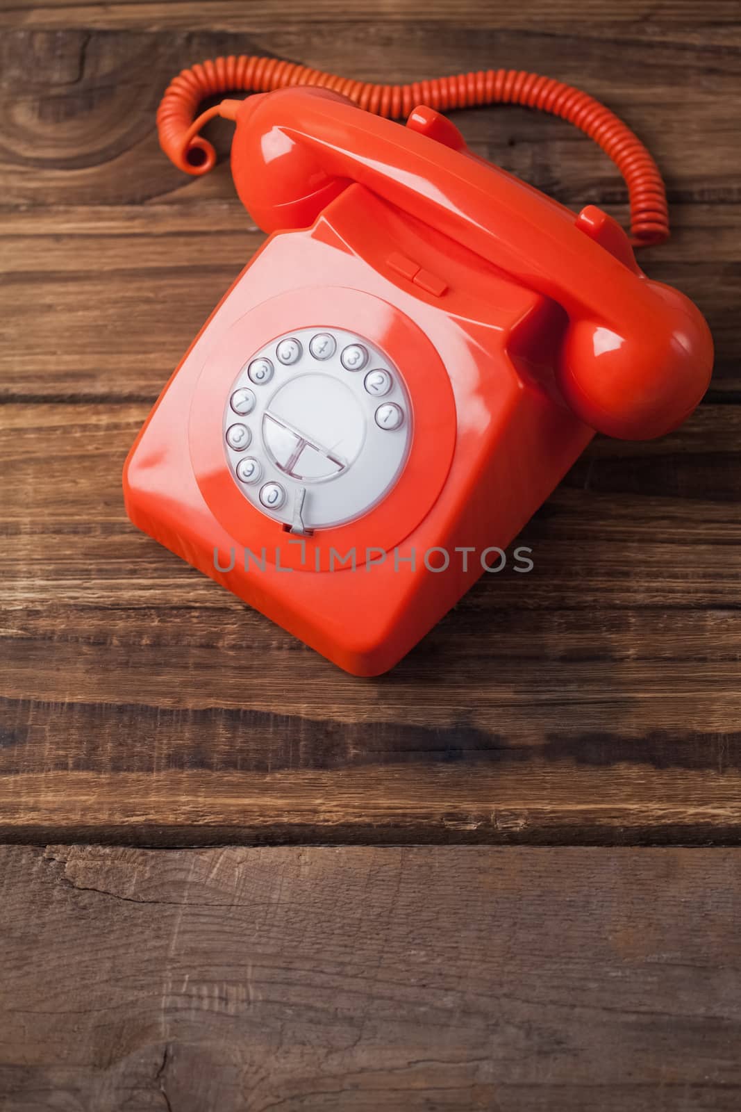 Red telephone on wooden table with copy space