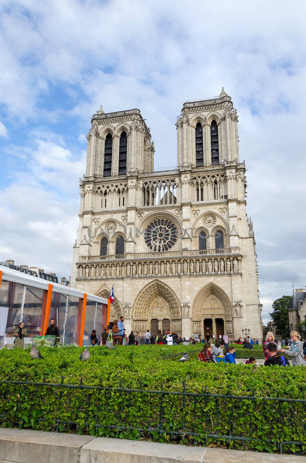 Paris, France - May 14, 2015: Tourists visiting the Cathedral of Notre Dame in Paris, France. on May 14, 2015. Notre Dame is one of the top tourist destinations in Paris.