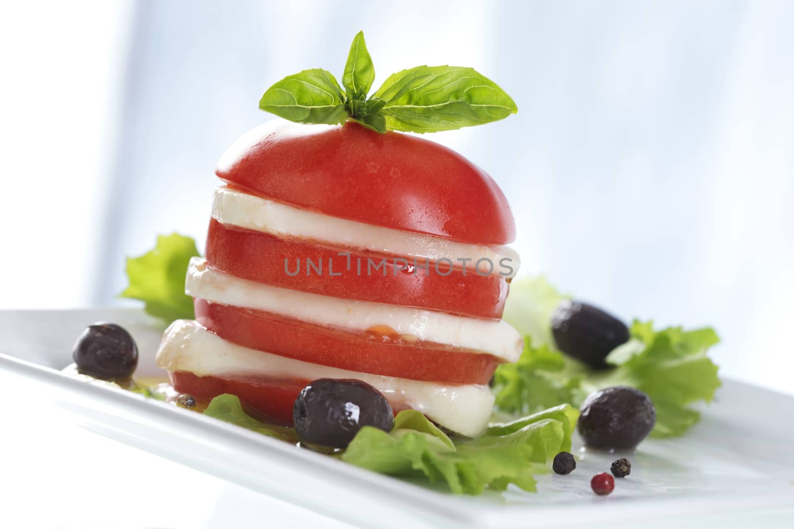 Tomato and mozzarella salad with basil decoration  by JPC-PROD