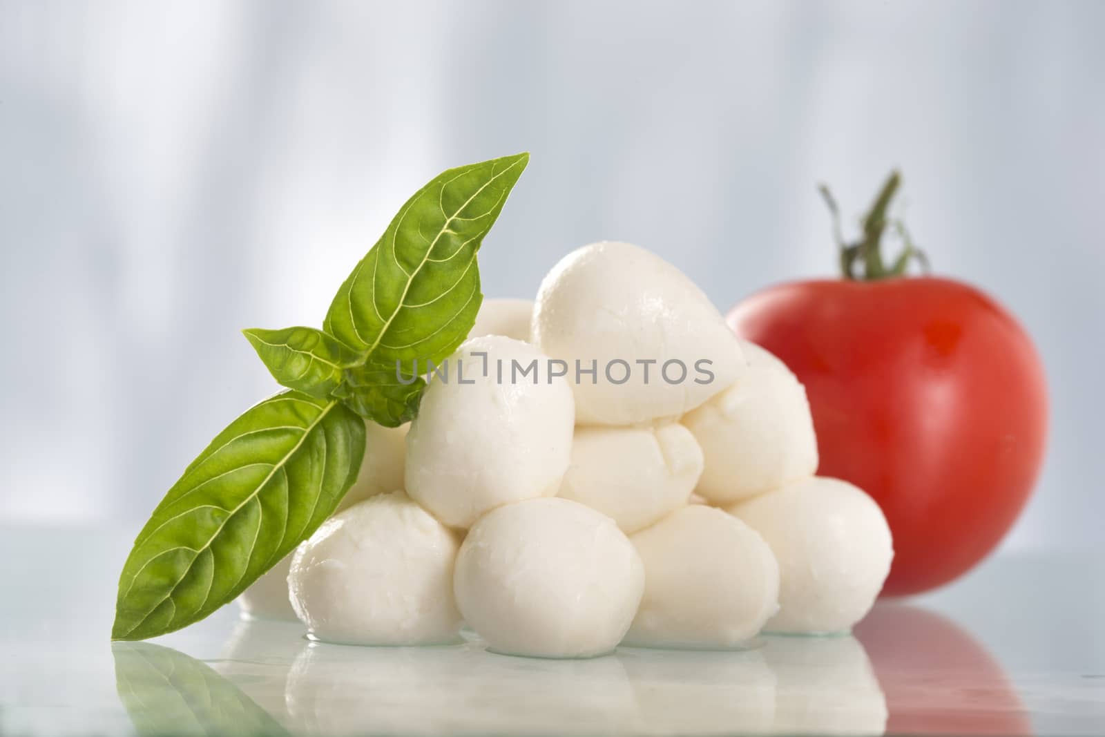 cheese mozzarella with green basil and tomato in glass plate