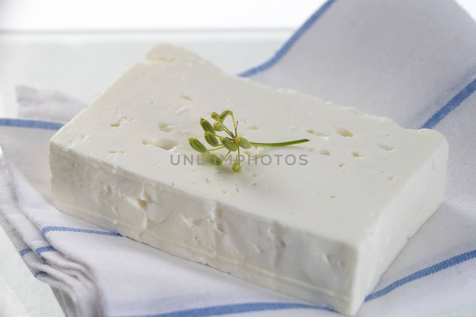 block of feta cheese with aromatic herbs