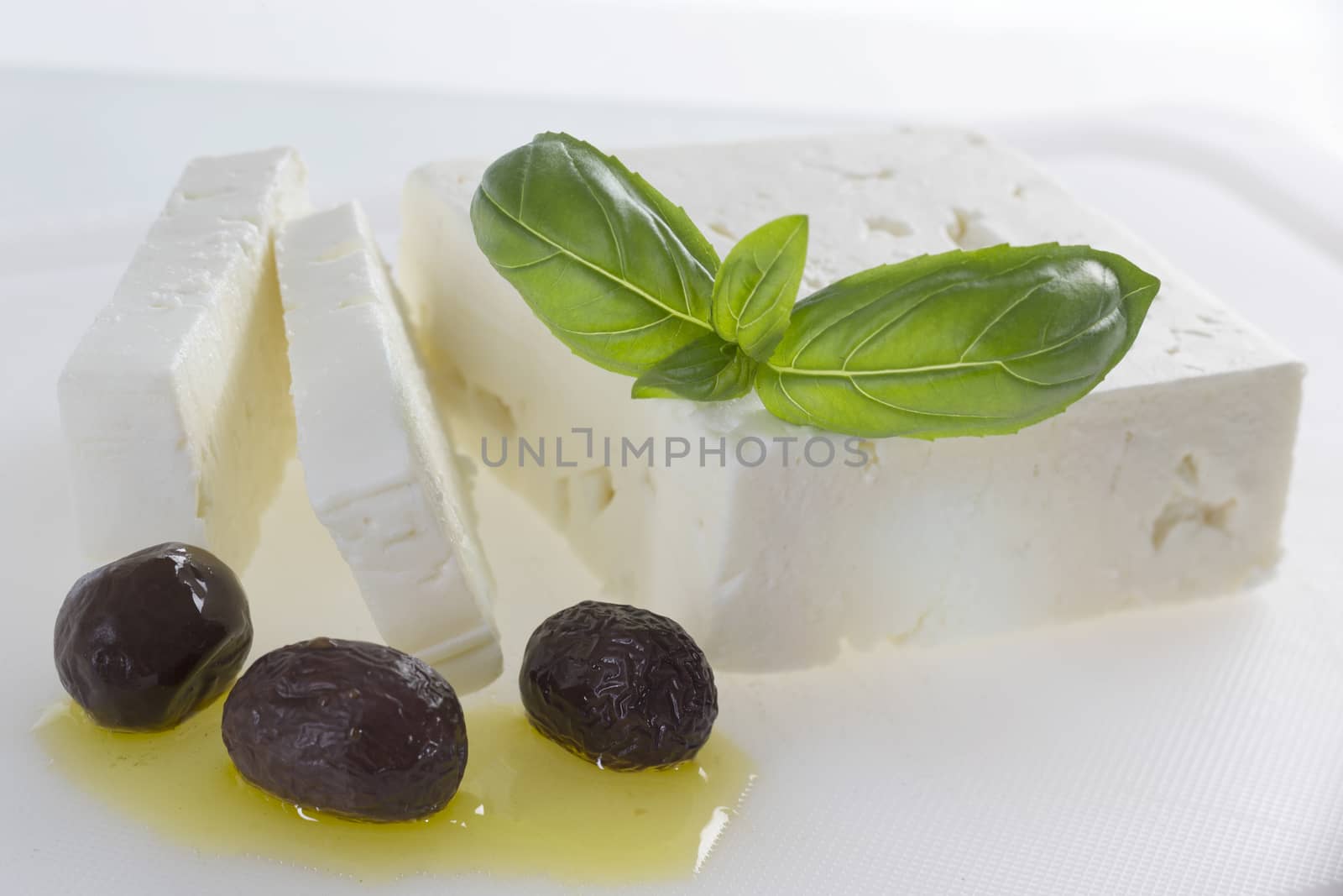 Traditional Greek feta cheesew with black olive on olive oil